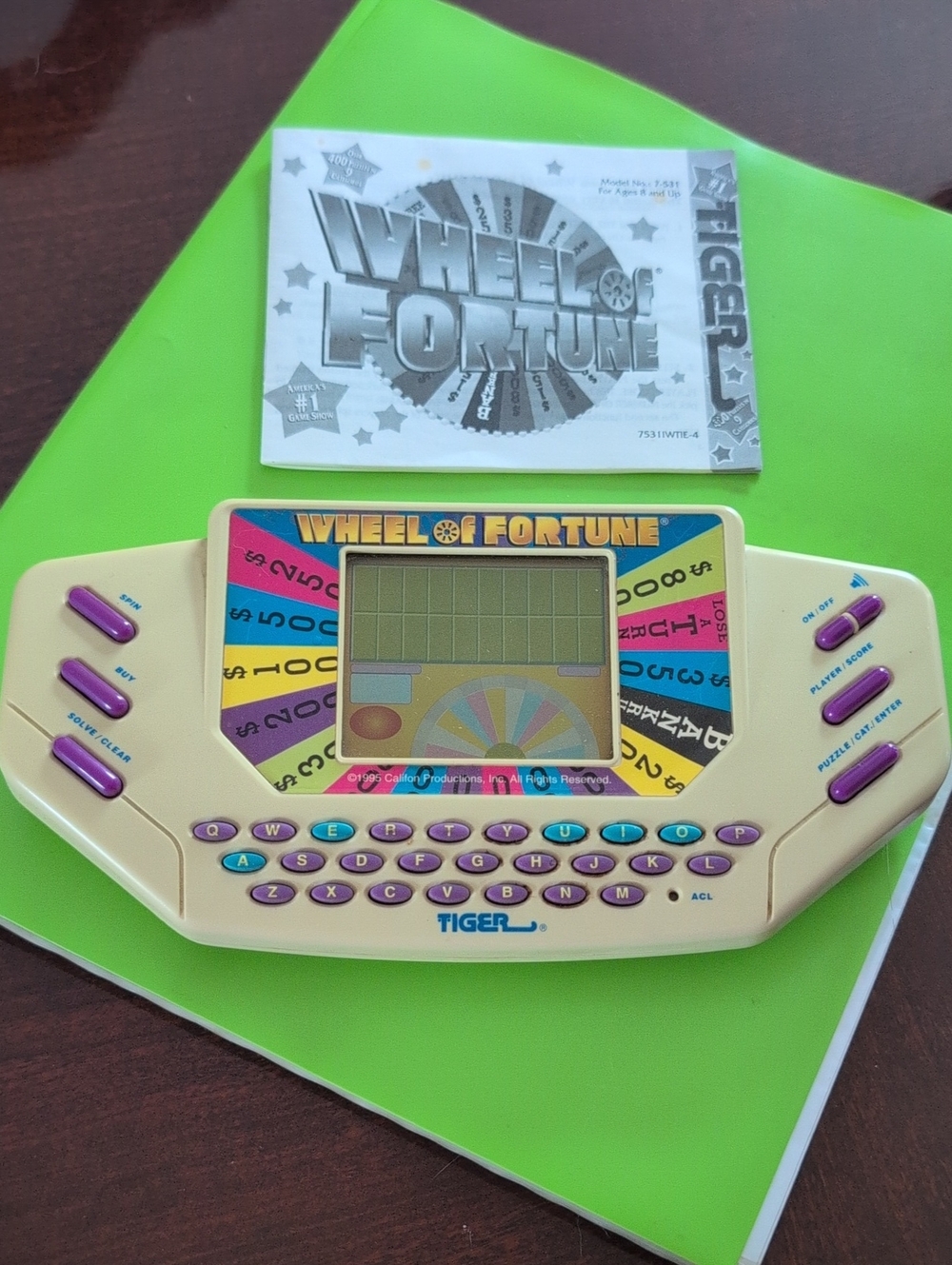 Tiger Electronics Wheel of Fortune Handheld Game - Cream and Purple